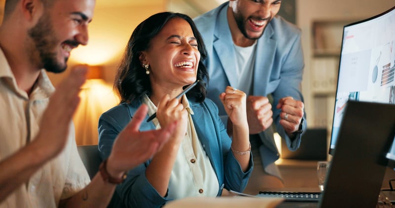 A women celebrating with her coworkers