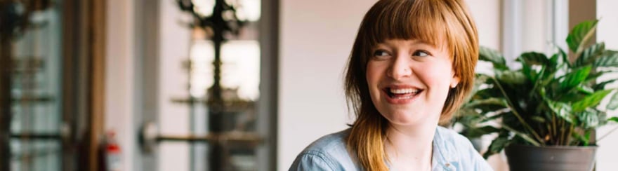 A photo of a women employee smiling at work 