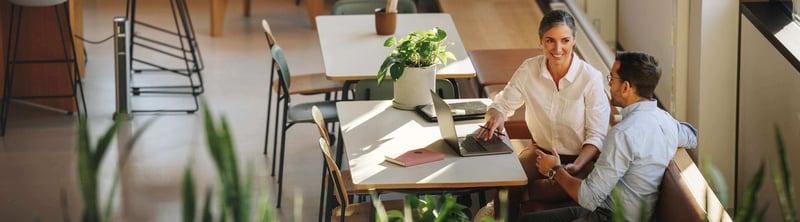 A women sitting at a desk with a laptop with her 